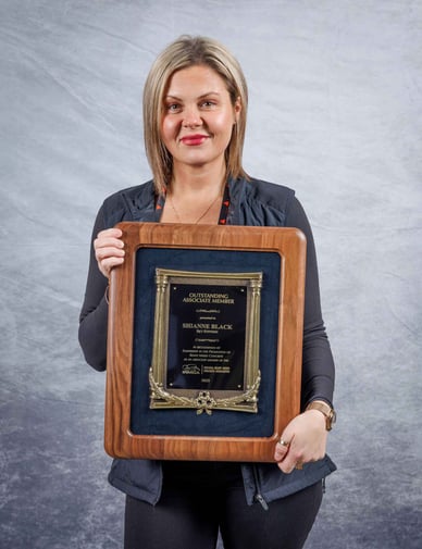 Shianne Black of Sky Systemz accepts the 2025 Associate of the Year Award from Indiana Ready Mixed Concrete Association on 01/13/2026.