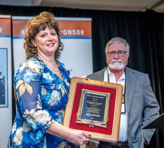 Rachelle Collins accepts the Carl D. Franks Award on behalf o her husband, Michael L. Collins.