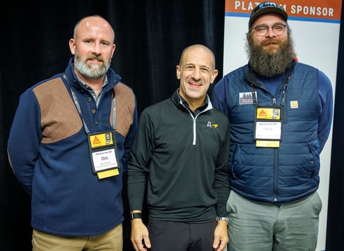 Keynote speaker Tony Kanaan pictured with keynote sponsors Chris Davenport and Nik Burton of Concrete Machinery Company at the IRMCA Winter Mixer 2026.